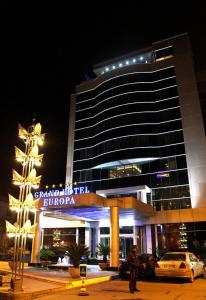 a building with a sign in front of it at night at Grand Hotel Europa in Shkodër