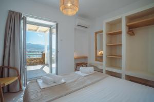 a bedroom with a bed with towels on top of it at 5 Elements - Agapi's Houses in Antiparos