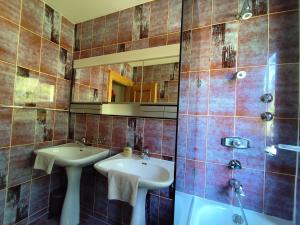 a bathroom with two sinks and a shower at Chalet Glauninger in Ramsau am Dachstein +38 photos