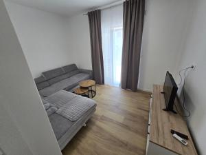 a living room with a couch and a television at Apartment Tome in Biograd na Moru