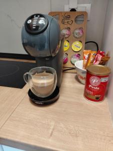 a coffee maker on a counter with a cup of coffee at Apartman Hedon in Vrnjačka Banja