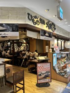 a fast food restaurant with people sitting at tables at 大津屋a in Yokohama