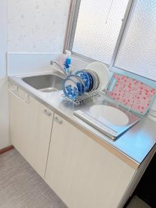 a kitchen counter with a sink and a window at 大津屋a in Yokohama +61 photos