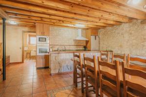 a kitchen with wooden ceilings and a counter top at Sanz in Castro de Fuentidueña