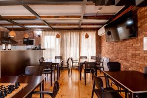 a restaurant with tables and chairs and a brick wall at Chateau Gremisio in Kvareli