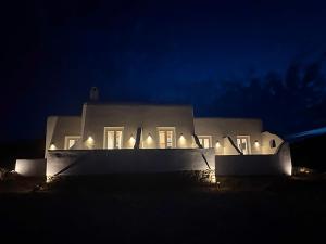 a white house at night with lights on it at CHARMA Mykonos in Kalo Livadi