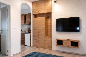 a living room with a flat screen tv on a wall at Blue Skies in Podgorica