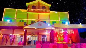 a colorful building with chairs in front of it at Prem Garden in Bhiwāni