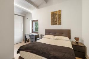 a bedroom with a large bed and a desk at Villa de Lujo Cerca de Sitges in Sant Pere de Ribes +36 photos