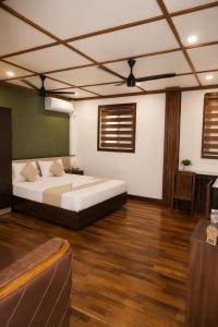 a bedroom with a large bed in a room at Nova North Inn in Cochin