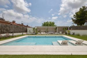 a swimming pool in the yard of a house at Villa de Lujo Cerca de Sitges in Sant Pere de Ribes