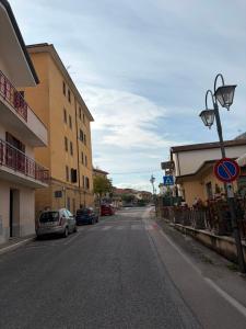 an empty street with cars parked on the side of a building at Albergo Maria Cristina in Esperia