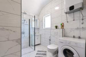 a white bathroom with a toilet and a shower at Apartments Ana in Gornji Karin +13 photos