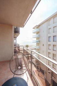 a balcony with a table and a chair at La bulle canetoise - vue mer in Canet-en-Roussillon