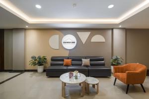 a living room with a couch and a table at Cove Juanda One in Jakarta