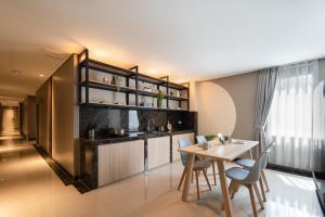 a kitchen and dining room with a table and chairs at Cove Juanda One in Jakarta +3 photos
