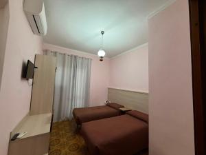 a small room with a bed and a couch at Albergo Maria Cristina in Esperia