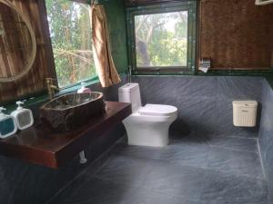 a bathroom with a toilet and a sink and a window at Tràng An Gold in Xuân Sơn +22 photos