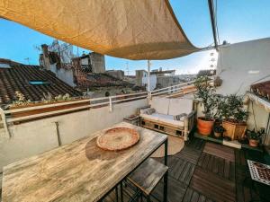 a balcony with a table and a couch on a roof at O Saudade - Centre Perpignan in Perpignan