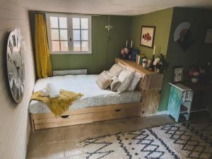 a bedroom with a bed and a clock on the wall at O Saudade - Centre Perpignan in Perpignan