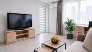 a living room with a large flat screen tv at K-49 prie Jūros in Klaipėda