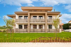 a large house with a lawn in front of it at Lazuli Apartment in Hegykő
