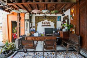 an office with a desk with chairs and a computer at Griya Gribig Guest House Mitra RedDoorz in Malang