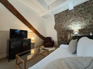 a hotel room with a bed and a tv at El Niu - Perpignan hyper centre in Perpignan +28 photos