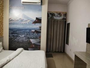 a room with a bed and a painting on the wall at hotel tamanna in Lucknow