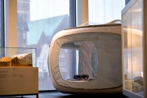 a large television sitting next to a window at One Night in a Museum - LUNA Sleep Cube in Lüneburg +13 photos
