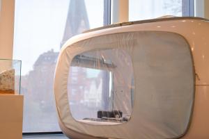 an old television sitting in front of a window at One Night in a Museum - LUNA Sleep Cube in Lüneburg
