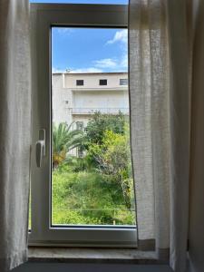 a window with a view of a building at Anfiteatro apartment in Formia