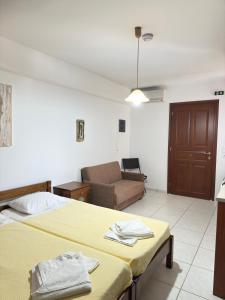 a hotel room with a bed and a couch at Calm Paros in Logaras