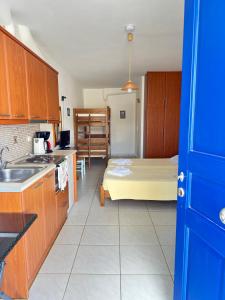 a kitchen with a bed in the middle of a room at Calm Paros in Logaras