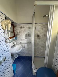 a bathroom with a shower and a sink at Anfiteatro apartment in Formia
