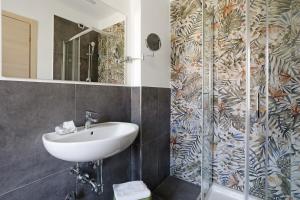 a bathroom with a sink and a shower at Domi Home in La Spezia +60 photos