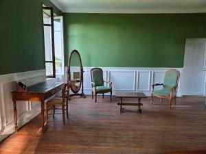 a room with chairs and a table and a mirror at Domaine de Lasserre in Lupiac +12 photos