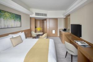 a hotel room with a large bed and a kitchen at Hopewell Hotel in Hong Kong