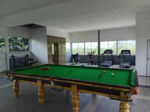 a room with a pool table and some exercise equipment at The Princess Beachfront Resort in Ban Tha Fat