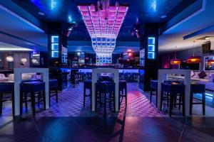 a bar with blue and white tables and stools at Spa Hotel Persenk in Devin
