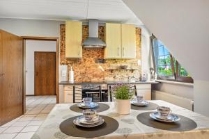 a kitchen with a table with two plates on it at Storchenallee in Burg
