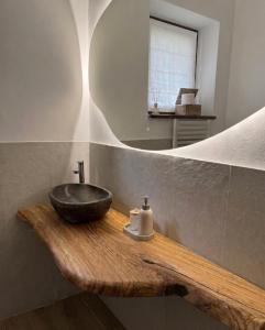a bathroom with a sink and a mirror at Appartamento alla Lupa in Vetriola +11 photos