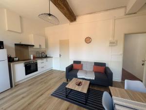 a living room with a couch and a table at Le Nomad - Perpignan center in Perpignan