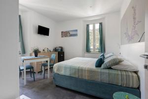 a bedroom with a bed and a table and a desk at Domi Home in La Spezia