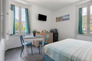 a bedroom with a bed and a table and chairs at Domi Home in La Spezia
