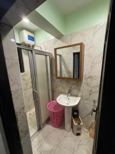 a bathroom with a sink and a mirror at JK properties in Kampala
