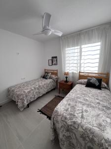 a bedroom with two beds and a ceiling fan at Eco Espacio Camaleón Verde 2 in Cartagena +28 photos