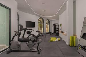 a gym with treadmills and exercise bikes in a room at Dioni Boutique Hotel in Preveza