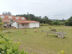 a yard with a bench and a house at Casa San Vicente Do Mar 3000 in O Grove