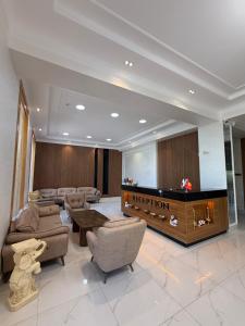 a waiting room with a television in a lobby at Safia Plaza Hotel in Bukhara